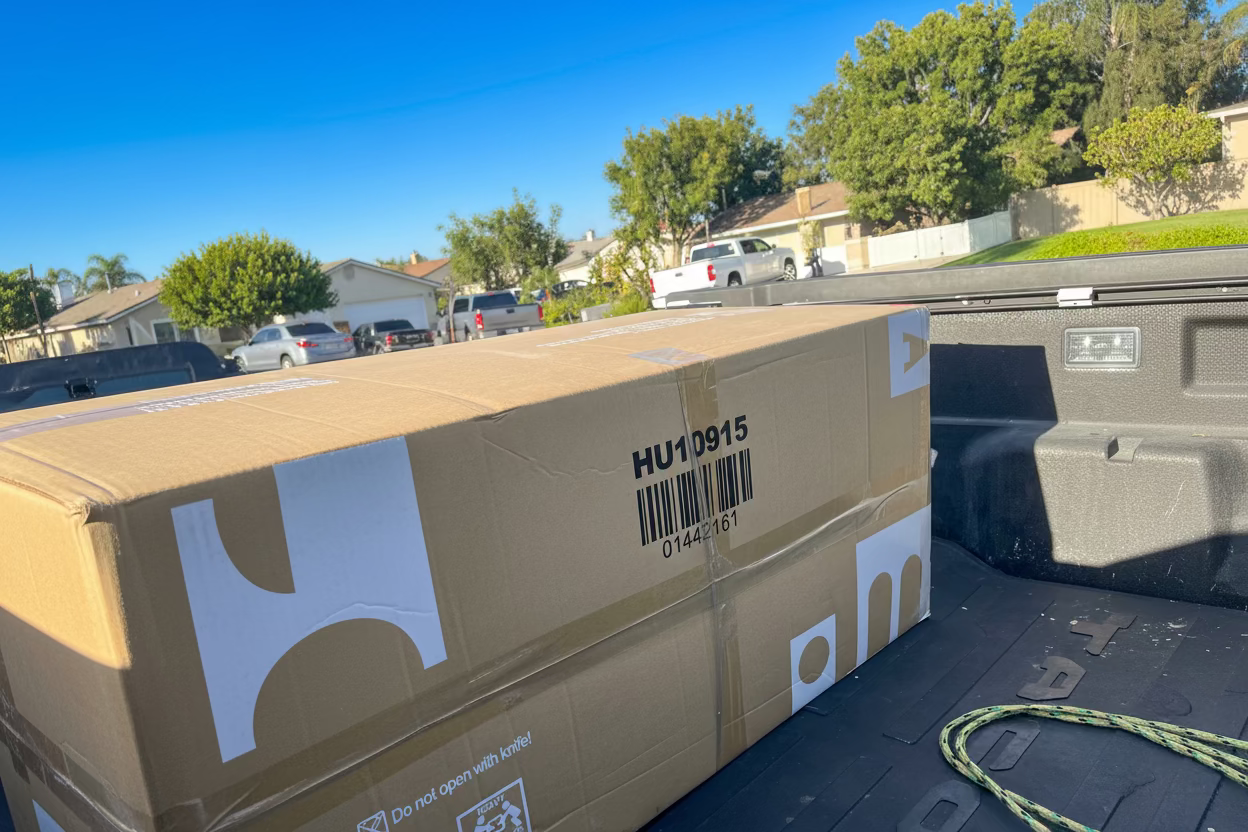Cardboard box with a barcode label on a vehicle's bed